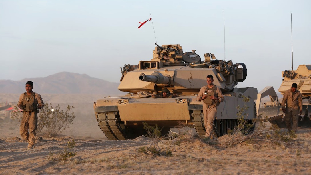 Lance Cpl. Patrick, left, loader, Company A, 1st Tank Battalion, 1st Marine Division, and a native of Houston, Texas, ground guides his tank named “Star Lord” during Exercise Desert Scimitar aboard Marine Corps Air Ground Combat Center Twentynine Palms, California, April 10, 2015. The training gave the Marines the opportunity to refine and rehearse essential combat skills needed in a battlefield environment. Desert Scimitar is an annual exercise that includes elements from the I Marine Expeditionary Force. The exercise focused on conventional operations and provided realistic training that prepared Marines for overseas operations. (U.S. Marine Corps photo by Sgt. Christopher J. Moore/Released)