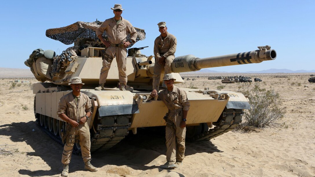Clockwise from top left, 1st Lieutenant John Neail, tank commander, Cpl. Christian Bills, gunner, Lance Cpl. Robert Benaridez driver, Lance Cpl. Patrick Bellinger, loader, the crew for the M1A1 Abrams Main Battle Tank named “Star Lord” participated in Desert Scimitar aboard Marine Corps Air Ground Combat Center Twentynine Palms, California. Desert Scimitar enables 1st Marine Division to test and refine its command and control capabilities and ensures 1st Marine Division units remain committed to consistently improving the quality of their training efforts and their resultant warfighting capabilities.