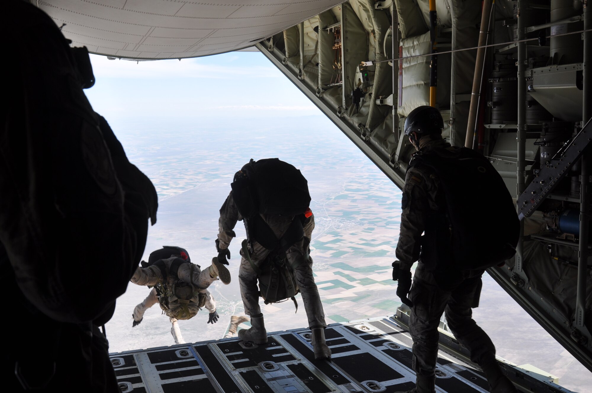 Spanish air force EZAPAC members perform a military free fall out of a U.S. Air Force MC-130J Commando II aircraft April 6, 2015, during ISIK, an international combat search and rescue event, while flying over Konya, Turkey. Military free fall is a skill that can be used to conduct personnel recovery and airfield establishment and control missions, which are the focus points for ISIK training events. (U.S. Air Force photo by Capt. Laura Balch)