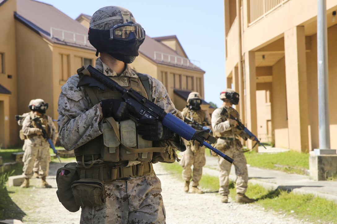 A Marine with Charlie Company, 1st Battalion, 8th Marine Regiment, scours through his surroundings during a counter improvised explosive device training exercise aboard Marine Corps Base Camp Lejeune, North Carolina, April 22, 2015. The Marines maintained awareness of any enemy or improvised explosive threat as they patrolled through an urban training town. They wore masks to protect their faces while using simulated rounds to suppress the mock-enemies. (U.S. Marine Corps photo by Cpl. Kaitlyn Klein/Released)