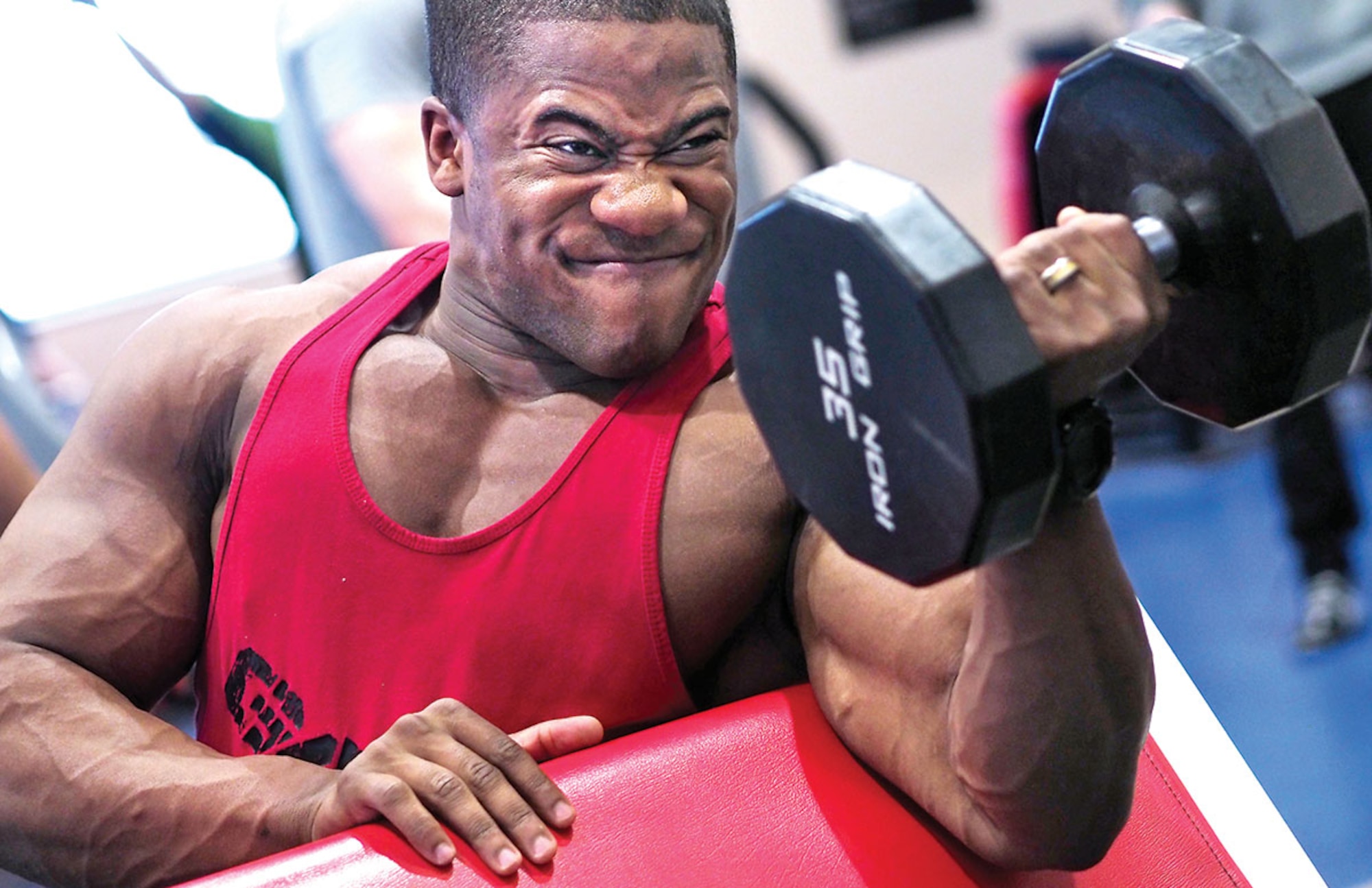 Airman 1st Class James Jones, a cyber systems operator assigned to the 673rd Communications Squadron, lifts a dumbbell at the Elmendorf Fitness Center April 20, 2015. Jones, a native of Ocean Springs Miss., took first place in his middleweight class, first overall in the men's category at the 2015 National Physique Committee Alaska State Championships on April 4. (U.S. Air Force photo/Justin Connaher)