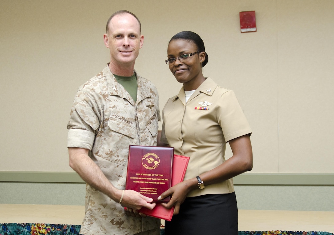 MARINE CORPS BASE HAWAII - Col. Eric W. Schaefer, the commanding officer of Marine Corps Base Hawaii, poses for a photo with Petty Officer 3rd Class Caroline Joel, a logistics specialist with Medial Logistics Platoon, Combat Logistics Battalion 3, after the Volunteer Recognition Ceremony in the Fairways Ballroom at the Kaneohe Klipper Golf Course, April 16, 2015. This is the third year in a row CLB-3 was chosen as the MCB Hawaii Volunteer Unit of the Year, and the second consecutive year an individual from their unit was chosen as the MCB Hawaii Volunteer of the Year. (U.S. Marine Corps photo by Kristen Wong/Released)
