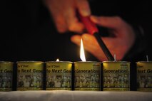 Chaplain Mark Hunsinger lights candles during the Holocaust memorial service at the base chapel on Hurlburt Field Fla., April 22, 2015. The memorial was held as a remembrance to honor those who lost their lives during the Holocaust. (U.S. Air Force photo by Senior Airman Meagan Schutter)