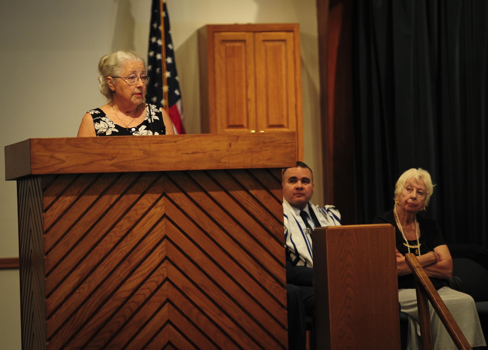 Brigitte Monturo speaks of her friend, an Auschwitz survivor, during the Holocaust memorial service held at the base chapel on Hurlburt Field Fla., April 22, 2015. The memorial was held as a remembrance to honor those who lost their lives during the Holocaust. (U.S. Air Force photo by Senior Airman Meagan Schutter)