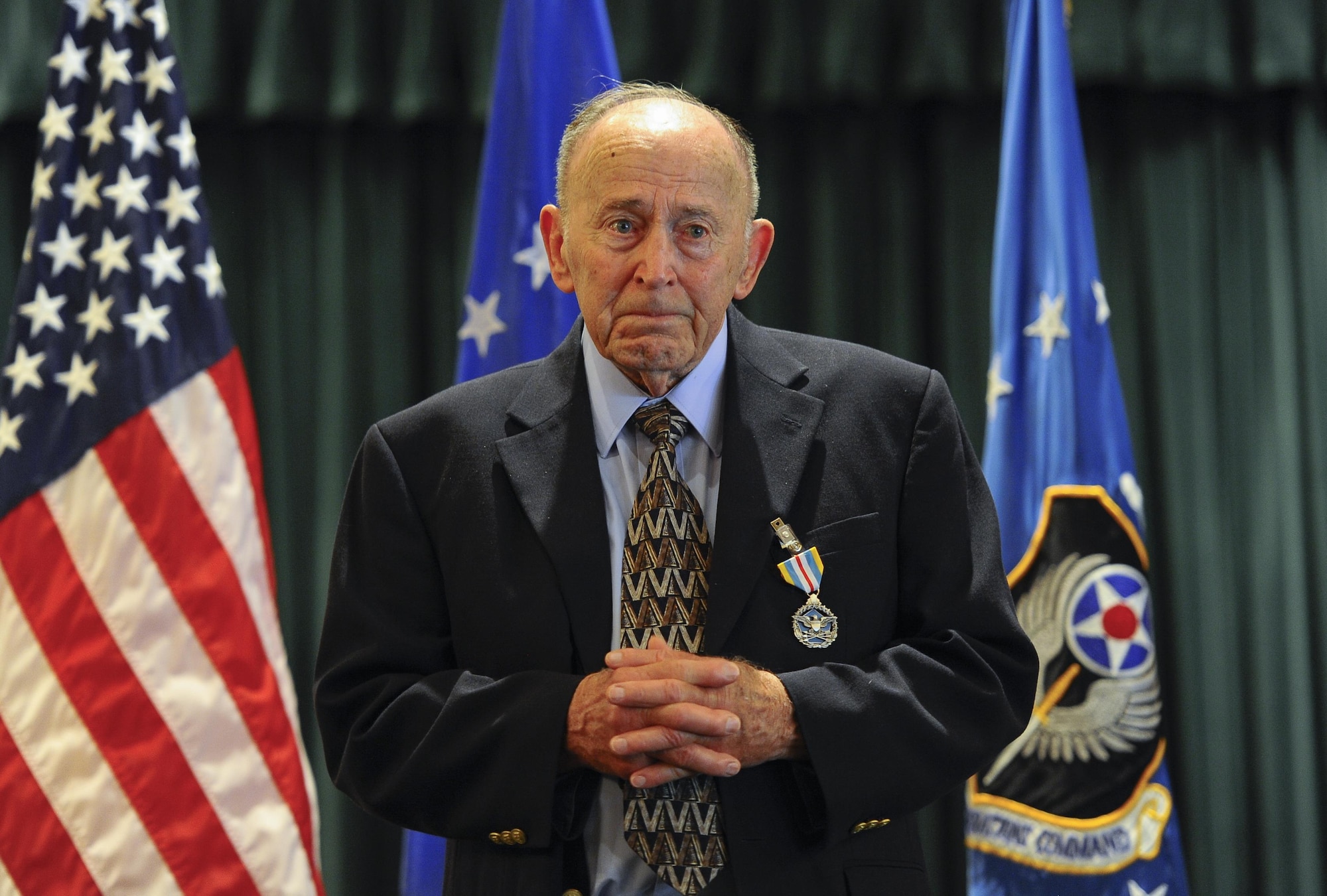 Retired Air Force Col. Thomas Wicker speaks during his medal presentation at the base chapel on Hurlburt Field, Fla., April 24, 2015. Lt. Gen. Heithold presented Wicker with the Defense Superior Service Medal for his role in Operation Eagle Claw. (U.S. Air Force photo by Amn Kai White)