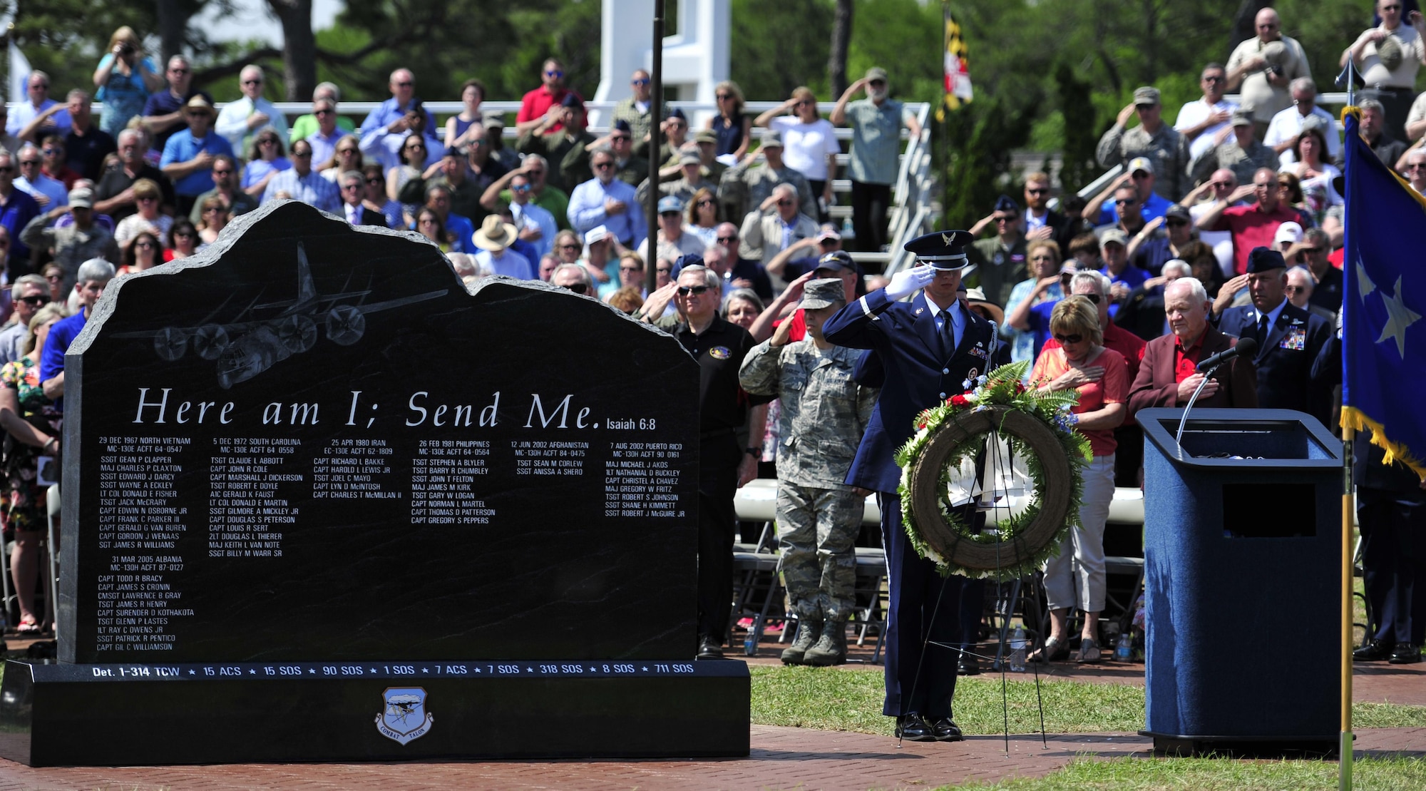 The audience pays their respect after an honor guardsman presents a wreath during the Combat Talon Memorial Dedication ceremony on Hurlburt Field, Fla., April 24, 2015. (U.S. Air Force photo/Staff Sgt. Melanie Holochwost)
