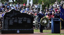 The audience pays their respect after an honor guardsman presents a wreath during the Combat Talon Memorial Dedication ceremony on Hurlburt Field, Fla., April 24, 2015. (U.S. Air Force photo/Staff Sgt. Melanie Holochwost)

