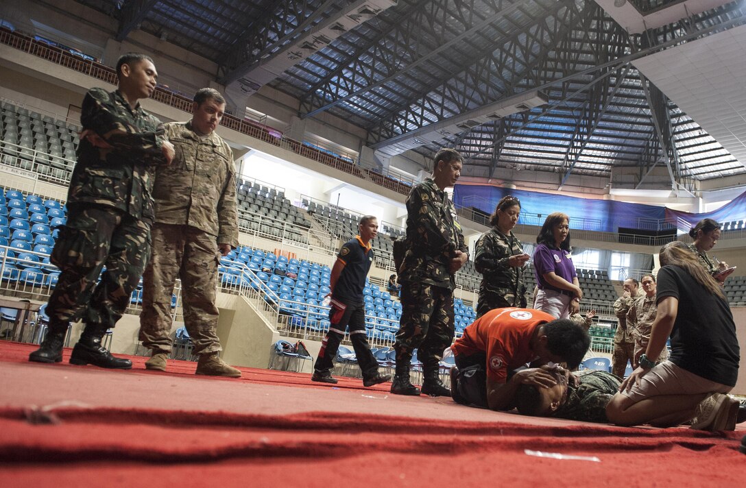 Armed Forces of the Philippines 1st Lt. Joseph Agbayani, left, Nurse Corps and first responder training course facilitator, and U.S. Army Staff Sgt. Bryan Garret, right, Alpha Company, Civil Affairs Battalion medic and Cooperative Health Engagement instructor, observe local health workers as they respond to a simulated mass casualty scenario during exercise Balikatan’s first responder training course in Puerto Princesa, Palawan, Philippines, April 22. U.S. military and AFP training instructors worked shoulder-to-shoulder to train 179 health workers and members of other local agencies to learn skills and techniques to better respond to a mass casualty. This year marks the 31st iteration of the exercise, which is an annual Philippine-U.S. bilateral military training exercise and humanitarian civic assistance engagement.
