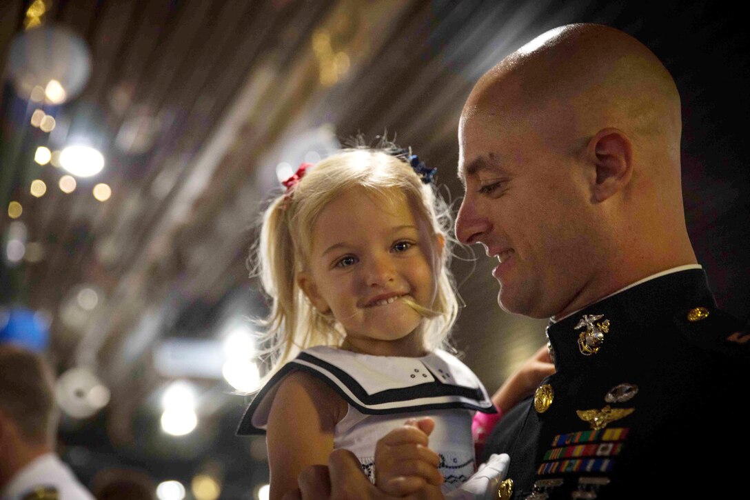 MARINE CORPS BASE HAWAII - Capt. Donald Kelly and his daughter share a moment at the Armed Services YMCA’s 16th Annual Father Daughter Dance at The Officers' Club aboard Marine Corps Base Hawaii, April 18, 2015. The theme for this year’s dance was “Under the Sea.” The dance stressed the importance of a father-daughter relationship and gave them an opportunity to spend quality time together. (U.S. Marine Corps photo by Cpl. Brittney Vella/Released)