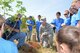 Col. Stephen Hoffman (center), 9th Mission Support Group commander, and students from Lone Tree School plant a tree in celebration of Earth Day April 22, 2015, at Beale Air Force Base, Calif. Team Beale planted more than 30 native trees. (U.S. Air Force photo by Airman 1st Class Ramon A. Adelan/Released)
