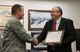 Robert Diaz Jr. (right), National Weather Service meteorologist in charge, presents Col. David Iverson, 366th Fighter Wing commander, with a certificate at Mountain Home Air Force Base, Idaho, April 23, 2015. StormReady communities are better prepared to react to severe weather. (U.S. Air Force photo by Airman 1st Class Jeremy L. Mosier/Released)