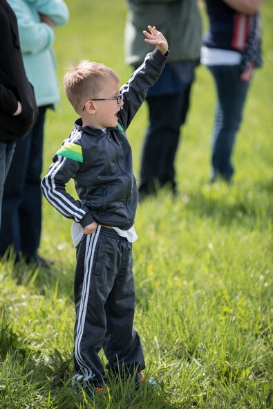 Asher Pentecost, son of Tech. Sgt. Donnie Pentecost of the 123rd Airlift Wing, waves goodbye to his father at the Kentucky Air National Guard Base in Louisville, Ky., April 24, 2015, as a C-130 Hercules aircraft caring more than 40 Airmen departs for deployment to an undisclosed air base in the Persian Gulf region. The Air Guardsmen will support airlift missions throughout the U.S. Central Command Area of Responsibility as part of Operation Freedom's Sentinel, which provides military training and counterterrorism capabilities in Afghanistan. (U.S. Air National Guard photo by Maj. Dale Greer)