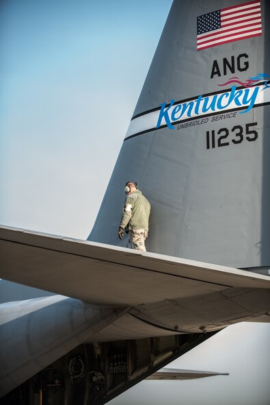 Airman 1st Class Jacob Reynolds, a crew chief in the 123rd Aircraft Maintenance Squadron, inspects a C-130 Hercules aircraft at the Kentucky Air National Guard Base in Louisville, Ky., April 24, 2015. The aircraft and more than 40 members of the 123rd Airlift Wing are deploying to an undisclosed air base in the Persian Gulf region, where they will fly airlift missions in support of Operation Freedom's Sentinel. (U.S. Air National Guard photo by Maj. Dale Greer)