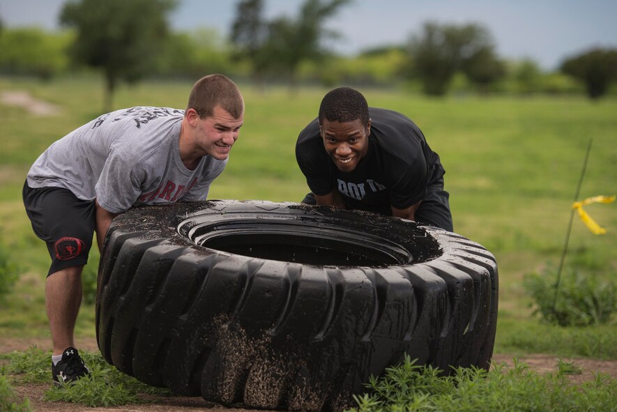 U.S. Air Force Airmen from Sheppard Air Force Base, Texas, work together to accomplish tasks during a base-wide Combat Barbeque obstacle course, April 24, 2015. Out of approximately 1,000 Airmen who attended, roughly 300 Airmen participated in the obstacle course. Airmen stayed together to push through rain, mud, sweat and freezing water, strengthening social, physical and mental fitness. (U.S. Air Force photo by Senior Airman Kyle Gese/Released) 