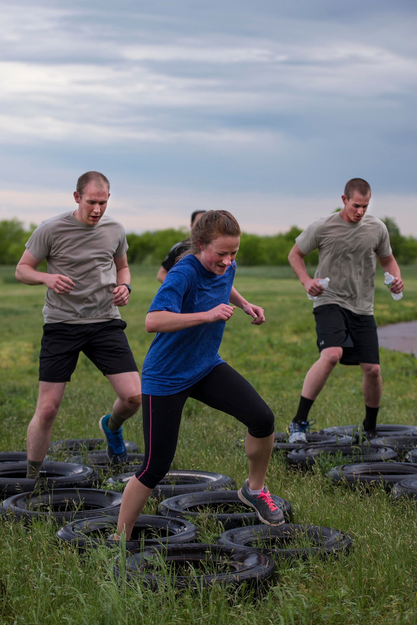 U.S. Air Force Airmen from Sheppard Air Force Base, Texas, maneuver through a tire obstacle during the base-wide Combat Barbeque, April 24, 2015. The barbeque brought more than 1,000 Airmen together; building teams and strengthening morale to bolster a professional Airmen culture. (U.S. Air Force photo by Senior Airman Kyle Gese/Released)
