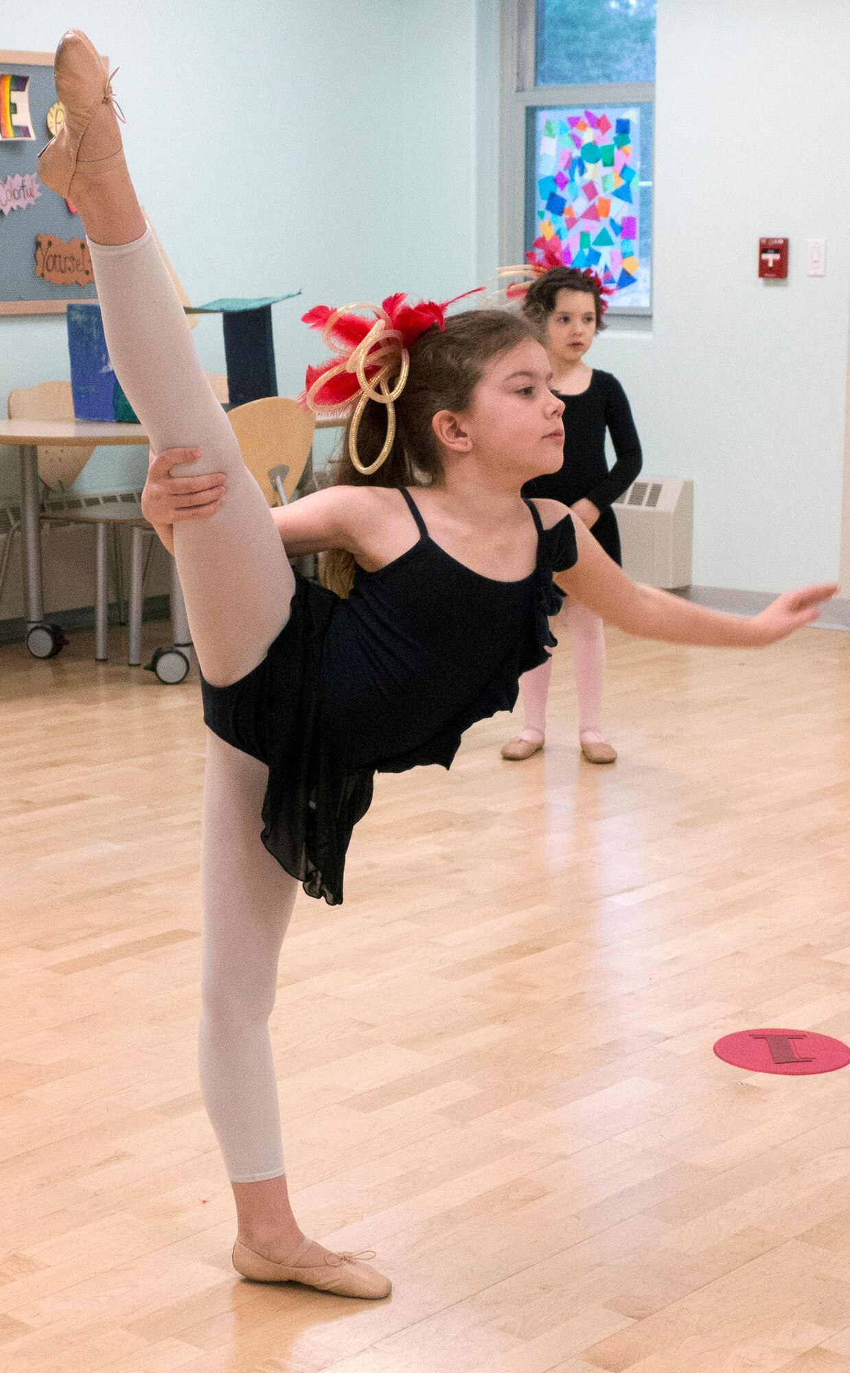 Alexis Norman, 8, performs an arabesque penché on Joint Base Elmendorf-Richardson, Alaska, April 16, 2015. Norman was practicing her moves during rehearsal for an upcoming recital May 3, 2015. Norman is the daughter of Senior Airman Randy Norman, 525th Aircraft Maintenance Unit dedicated crew chief. (U.S. Air Force photo/Airman 1st Class Tammie Ramsouer)