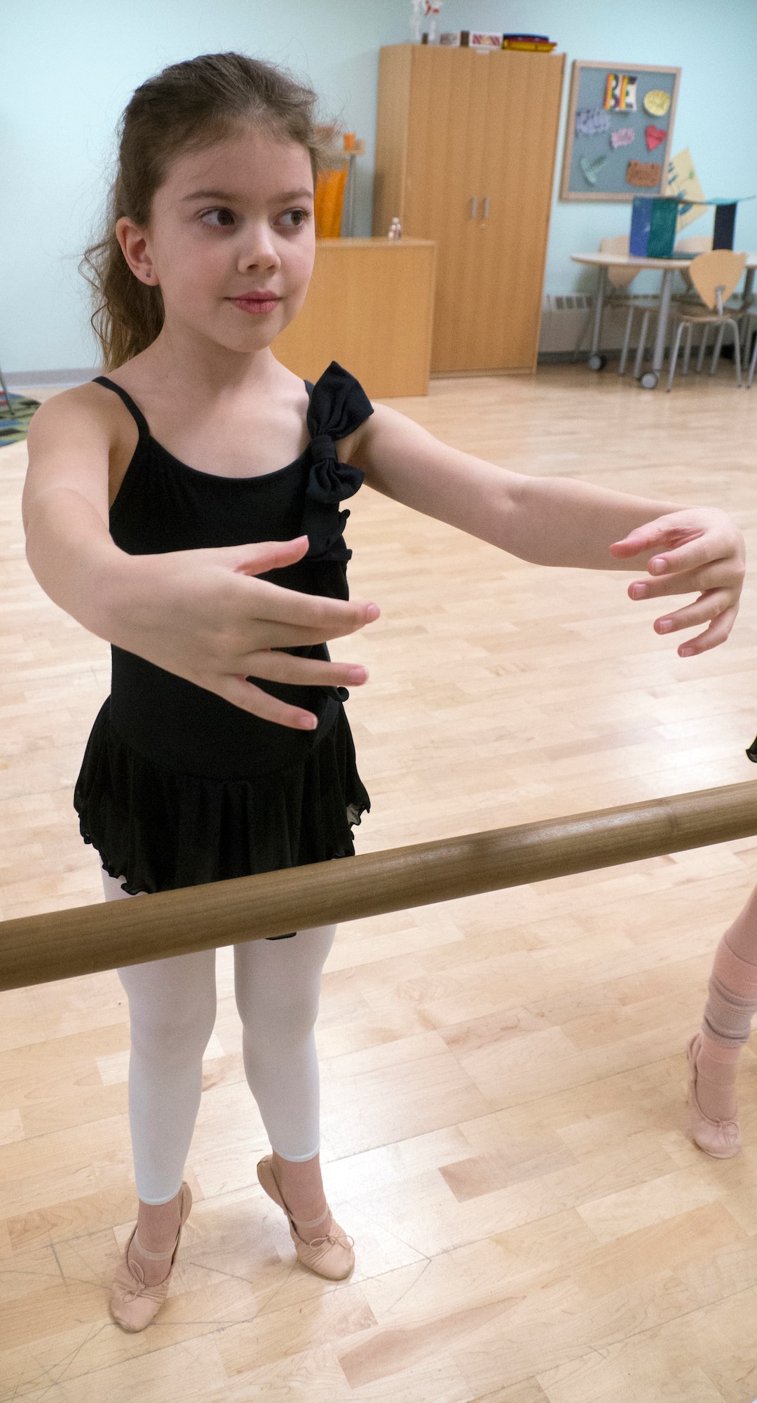 Alexis Norman, 8, stands in a grand plie position during a ballet class at the Illa School Age Program on Joint Base Elmendorf-Richardson, Alaska, April 16, 2015. The students learn how to gracefully perform ballet moves and stretching techniques during each weekly class. Ballet is one of many classes children can participate in through the Youth Instructional Program on JBER. Other classes include, but are not limited to, gymnastics, music and hip-hop dancing. Norman is the daughter of Senior Airman Randy Norman, 525th Aircraft Maintenance Unit dedicated crew chief. (U.S. Air Force photo/Airman 1st Class Tammie Ramsouer)