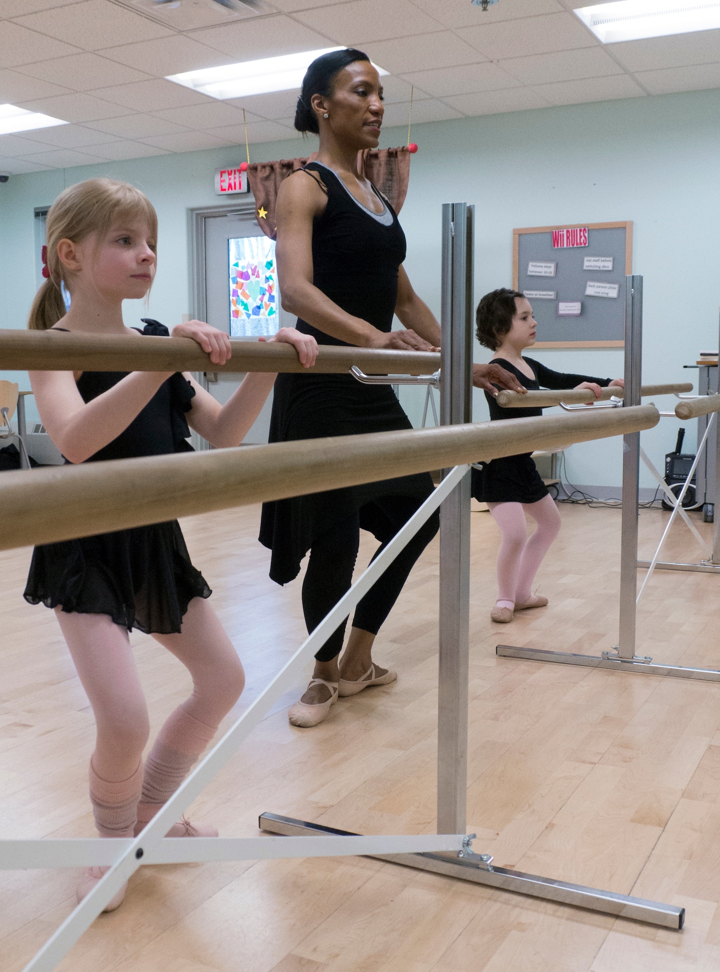 Noemia Howell, Youth Instructional Program ballet instructor, performs plies with Allie Akers, 8 (left) and Audreena Smith, 7 (right) at the Illa School Age Program on Joint Base Elmendorf-Richardson, Alaska, April 16, 2015. Akers and Smith are practicing for their recital May 3, 2015. Akers is the daughter of Lt. Col. James Akers, 90th Fighter Squadron commander, and Smith is the daughter of Master Sgt. Thomas Smith, 673d Civil Engineer Squadron first sergeant. (U.S. Air Force photo/Airman 1st Class Tammie Ramsouer)