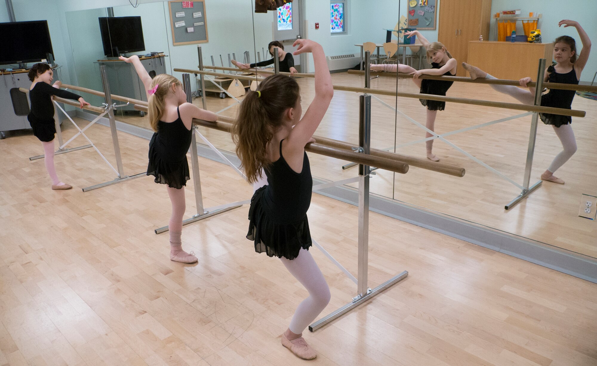 From left to right, Audreena Smith, 7, Allie Akers, 8, and Alexis Norman, 8, performs a barre isyk at the Illa School Age Program on Joint Base Elmendorf-Richardson, Alaska, April 16, 2015. The class provides children the opportunity to practice balance and grace. Ballet is one of many after-school classes available to children on JBER. Smith is the daughter of Master Sgt. Thomas Smith, 673d Civil Engineer Squadron first sergeant, Akers is the daughter of Lt. Col. James Akers, 90th Fighter Squadron commander, and Norman is the daughter of Senior Airman Randy Norman, 525th Aircraft Maintenance Unit dedicated crew chief. (U.S. Air Force photo/Airman 1st Class Tammie Ramsouer)