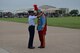 Col. Edwards presents King Antonio XCIII with the 2015 Fiesta Medallion during the Fiesta Military Parade at JBSA Lackland, 17 April 2015. 