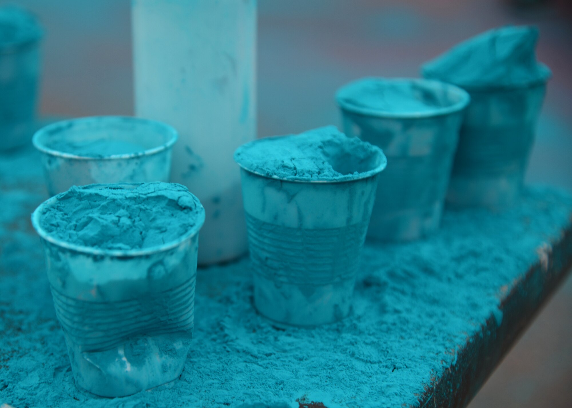 Cups of blue chalk wait to be thrown at runners during the Color Me Run on Barksdale Air Force Base, La., April 24, 2015. The blue chalk represents child abuse prevention, and is also one of five helping agencies taking part in the 5k event. (U.S. Air Force photo/Senior Airman Joseph A. Pagán Jr.)