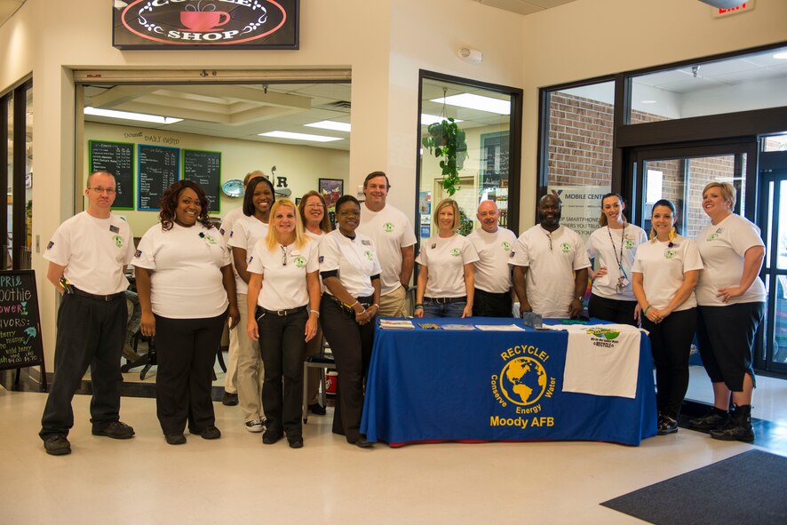The 23d Civil Engineer Squadron environmental team and Base Exchange staff members pose for a group photo at an Earth Day stand April 22, 2015, at Moody Air Force Base, Ga. The BX staff members all wore Earth Day T-Shirts to promote better care of the environment. (U.S. Air Force photo by Airman 1st Class Dillian Bamman/Released)
