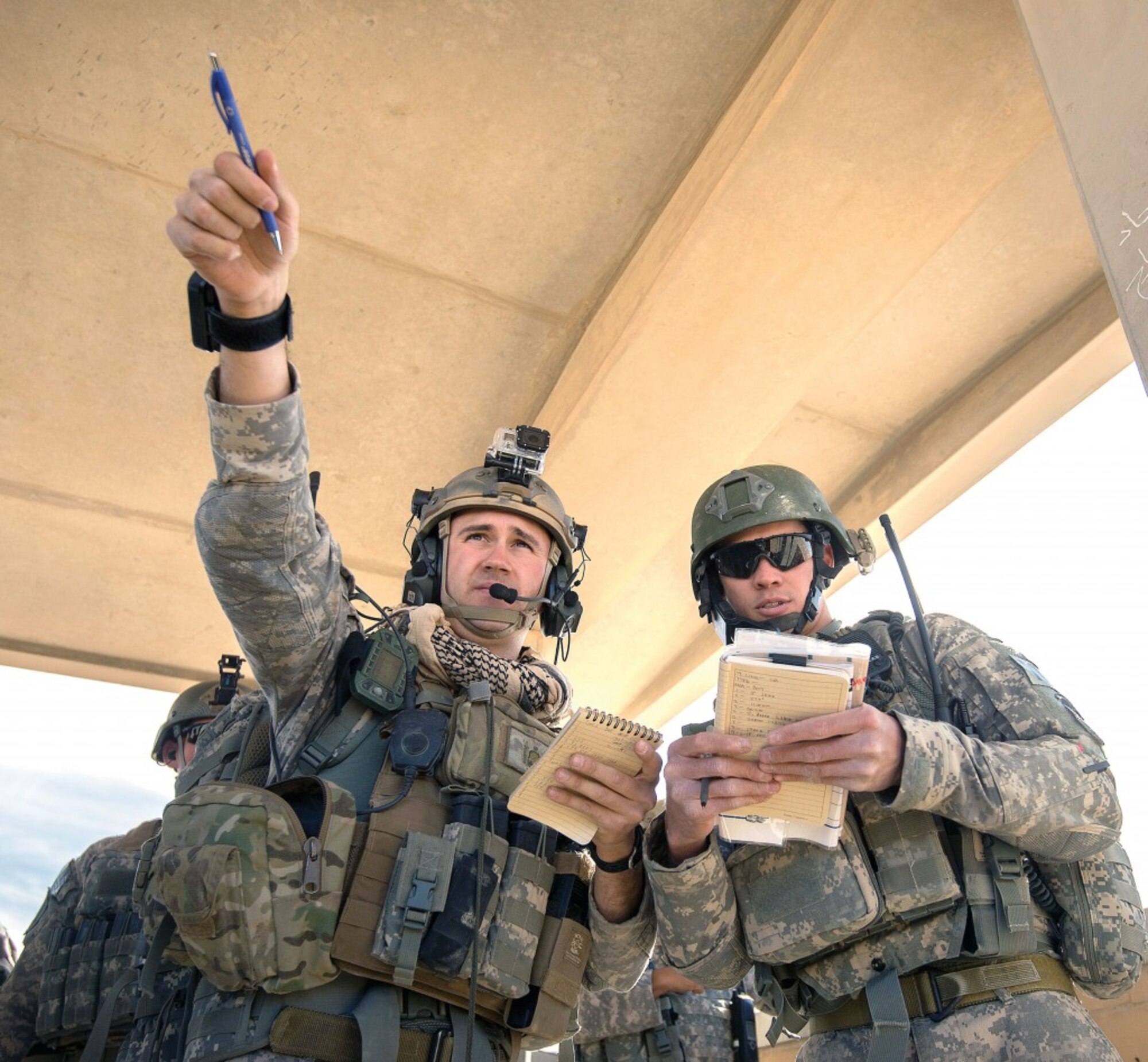 Senior Airman Justin Tamayo (right), 13th Air Support Operations Squadron tactical air control party, assists a joint terminal attack controller with identifying targets and controlling aircraft during a deployment exercise in Kuwait. (Photo courtesy 13th ASOS)
