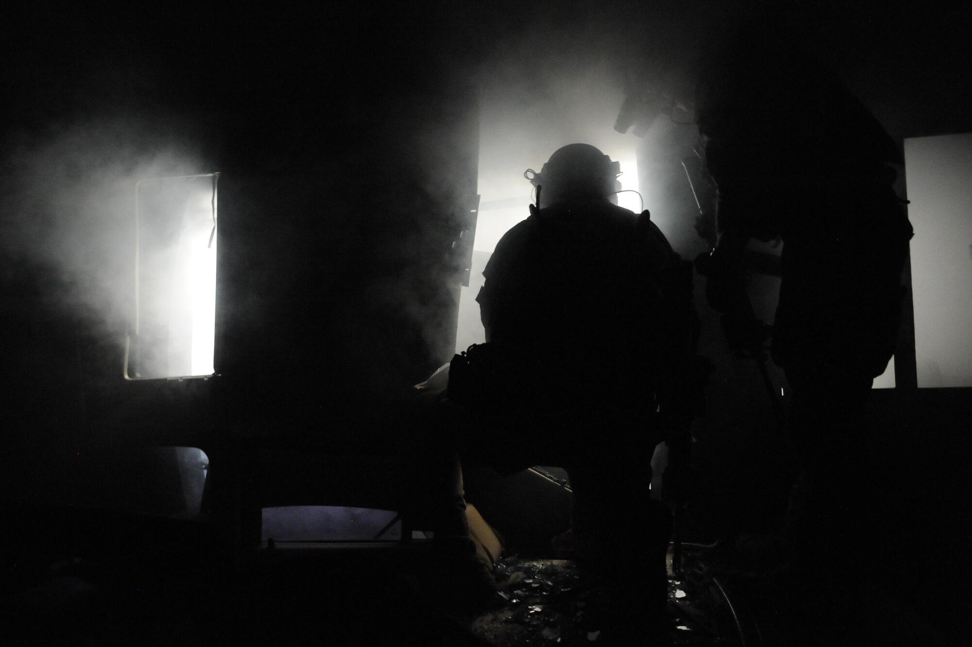 A U.S. Air Force Pararescueman, 48th Rescue Squadron, prepares to access a simulated crashed helicopter during a pre-deployment training exercise at Davis-Monthan Air Force Base, Ariz., April 14, 2015. The exercise focused on mass casualty treatment, evacuation, extrication, confined space and collapsed structure rescue.  (U.S. Air Force photo by Senior Airman Betty R. Chevalier)