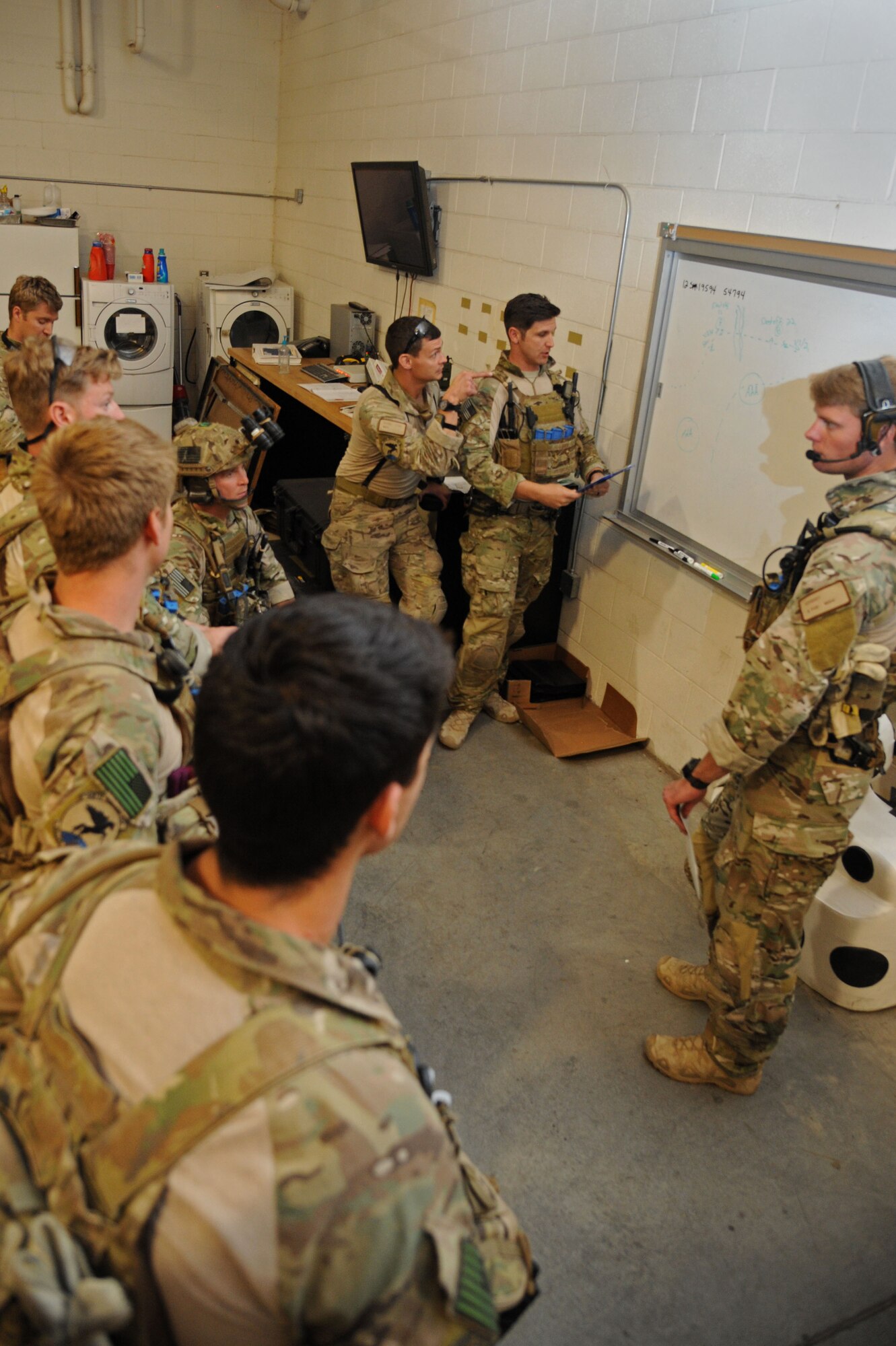A 48th Rescue Squadron team discusses how to accomplish a mission during a pre-deployment training exercise at Davis-Monthan Air Force Base, Ariz., April 14, 2015. Rescue Teams are capable of staging and evacuation, surface and subsurface maritime, confined space and collapsed structure extrication, high altitude and technical rescue. (U.S. Air Force photo by Senior Airman Betty R. Chevalier)