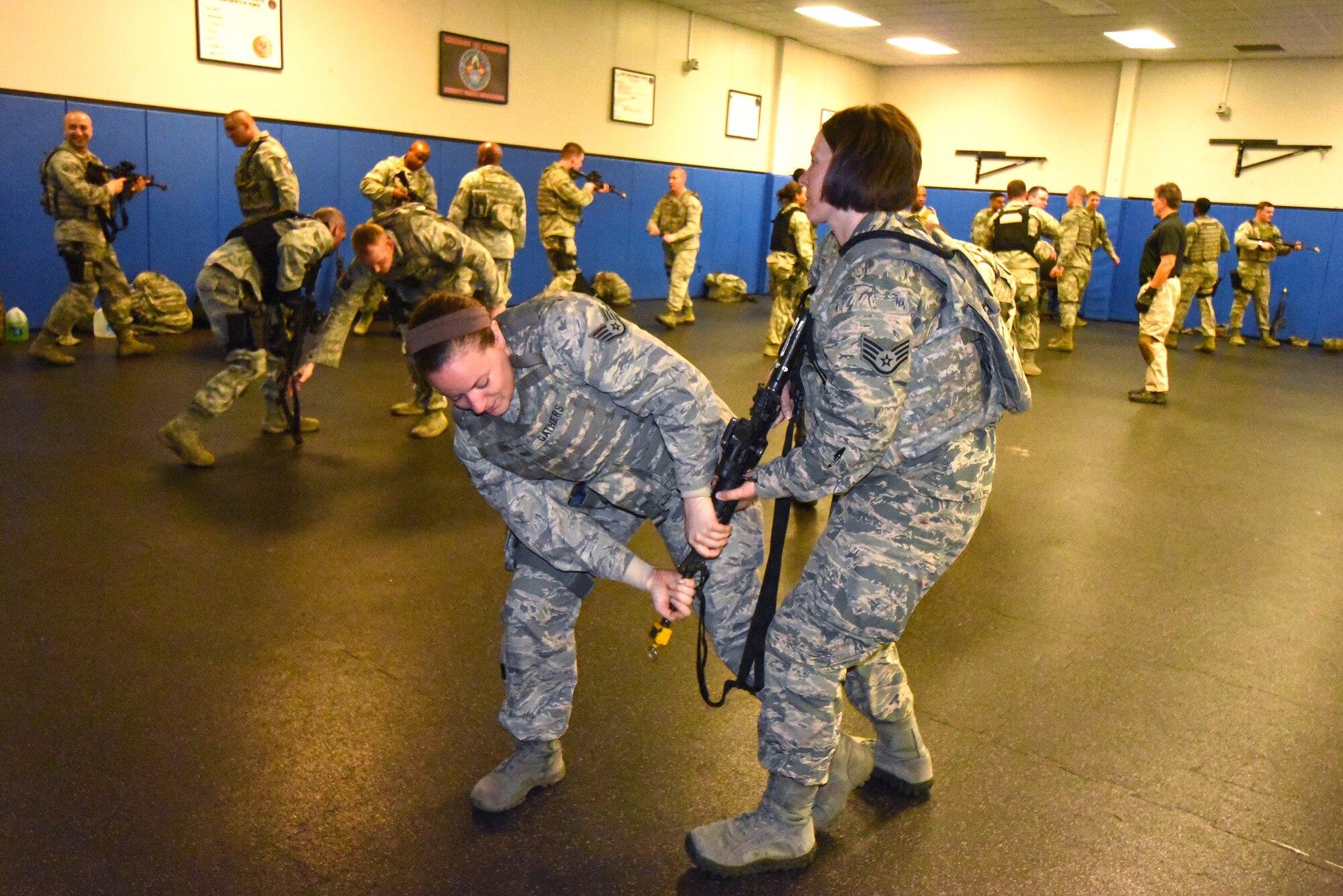 Staff Sgt. Theresa Gathers, Air Combat Command Headquarters, Joint Base Langley-Eustis, (left) and Staff Sergeant Elizabeth Bilyeu, 571 Global Mobility Readiness Squadron, Travis Air Force Base, practice weapon takeaway defense strategies during an advanced weapons and tactics course for Security Forces Airmen at the US Air Force Expeditionary Center, Joint Base McGuire-Dix-Lakehurst on April 14, 2015.  