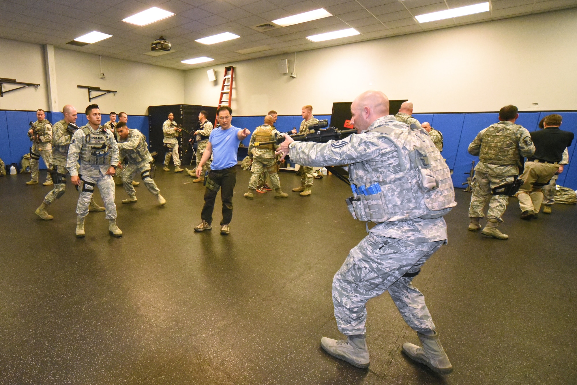 Thong Nguyen, Progressive Combat Solutions instructor, explains the technique of a frontal charge advance to Staff Sgt. Andres Rojas, 6th Security Forces Squadron, MacDill Air Force Base (left) and Master Sgt. James Ashby, 99th Security Forces Squadron, Nellis Air Force Base, during an advanced tactical training course at the US Air Force Expeditionary Center, Joint Base McGuire-Dix-Lakehurst on April 14, 2015. 50 Security Forces Airmen from around the Air Force were brought together to attended a week long weapons and tactics course as part of a continuation initiative to transition weapons training from a qualification-focus to a proficiency-focus.