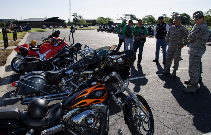 Judges inspect motorcycles during the Bike Judging Competition at the Annual Motorcycle Riders Safety Brief, April 24, 2015 at Joint Base Charleston – Air Base, S.C. Col. Jimmy Canlas, 437th Airlift Wing vice commander, Chief Master Sgt. Chris Robinson, 437th Maintenance Group chief enlisted manager, and Chief Master Sgt. Robert Valenca, 628th Mission Support Group chief enlisted manager, served as judges for the event. Bikes were split into four categories: Custom Bikes, Cruisers, Sport Bikes and Commander’s Choice.  (U.S. Air Force photo/Staff Sgt. AJ Hyatt)