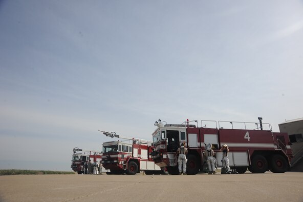 Firefighters of the 509th Civil Engineer Squadron arrive to the training area and suit up for fire pit training at Whiteman Air Force Base, Mo. April 2, 2015. The exercise is held monthly to ensure Airmen are familiar with fire procedures. (U.S. Air Force photo by Airman 1st Class Jovan Banks/Released)