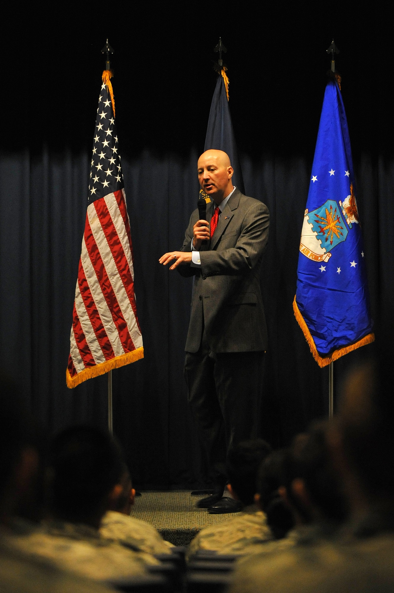 The Honorable John Peter Ricketts, Governor of Nebraska, speaks to junior enlisted on leadership April 15 in the Bennie Davis Maintenance Facility auditorium, Offutt Air Force Base, Nebraska. His lecture was part of the first bi-annual Airmen Leadership Conference. (U.S. Air Force photo by Josh Plueger/Released)