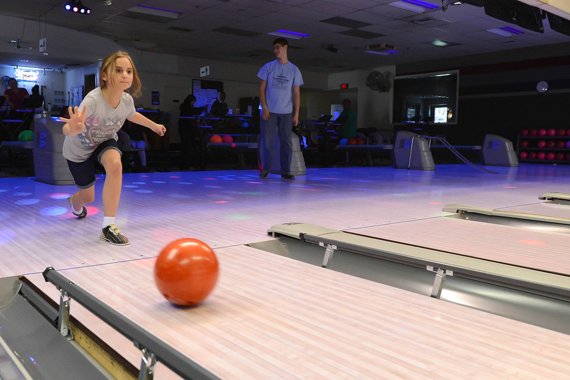 Ava Leinart flings a bowling ball down the center of the bowling lane during a Spring Striketacular event at the base bowling center, April 22. Several base families participated in the school vacation special hosted by the Hanscom Lanes bowling center.  (U.S. Air Force photo by Jerry Saslav)