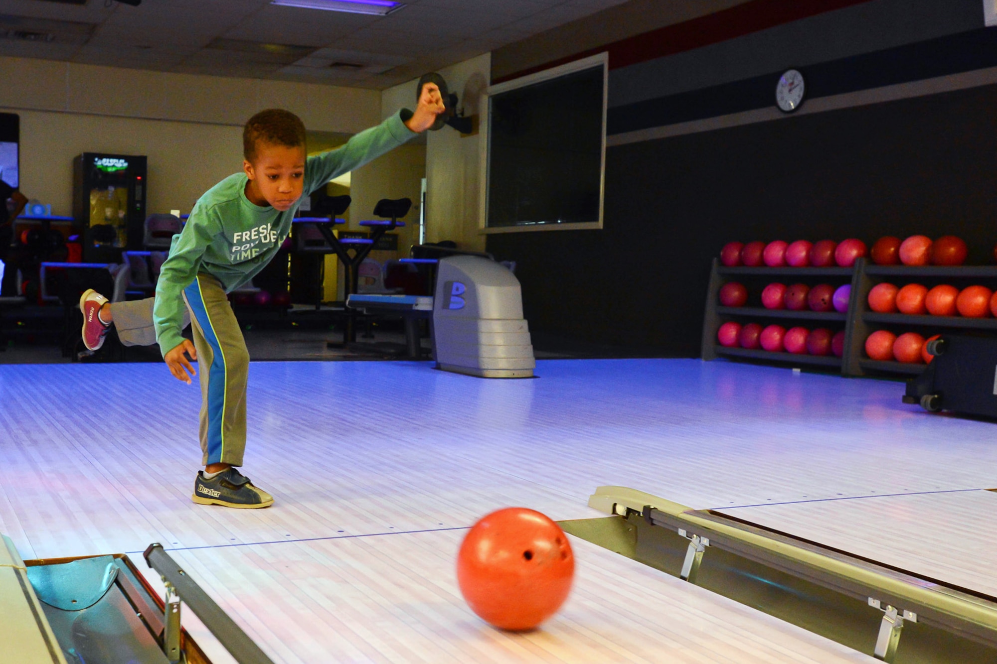 Quincy Carter sends a bowling ball hurtling down the lane at the Hanscom Lanes bowling center as his family bowls, April 22. Hanscom Lanes held a Spring Striketacular event for families over the week-long school vacation.  (U.S. Air Force photo by Jerry Saslav)