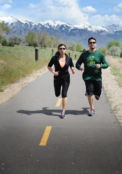Wounded Air Force combat veteran Mary Barnett, a program manager with the Air Force Lifecycle Management Center here, runs around the Hill AFB duck pond trail with her husband and running partner David. Barnett runs marathons despite having a heart condition from a mortar blast in Iraq. She doesn't let the pacemaker she has to wear restrict her freedom. (U.S. Air Force photo/Micah Garbarino)