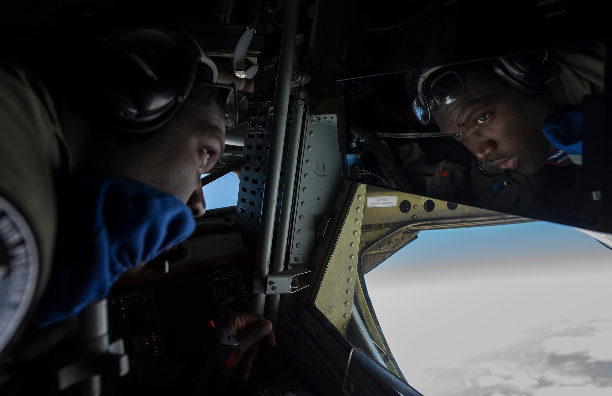 U.S. Air Force Senior Airman Devaughn Granger, an 871st Air Expeditionary Squadron boom operator, maneuvers the boom on a KC-135 Stratotanker aircraft while refueling an F-15C Eagle fighter aircraft over Iceland during the Icelandic Air Surveillance and Policing mission April 22, 2015. The boom operator is responsible for establishing and maintaining the link between the KC-135 and the aircraft receiving fuel. The IAS mission is a recurring NATO commitment designed to maintain the security of Icelandic airspace by providing a fighter aircraft presence in the region. (U.S. Air Force photo by Staff Sgt. Chad Warren/Released)