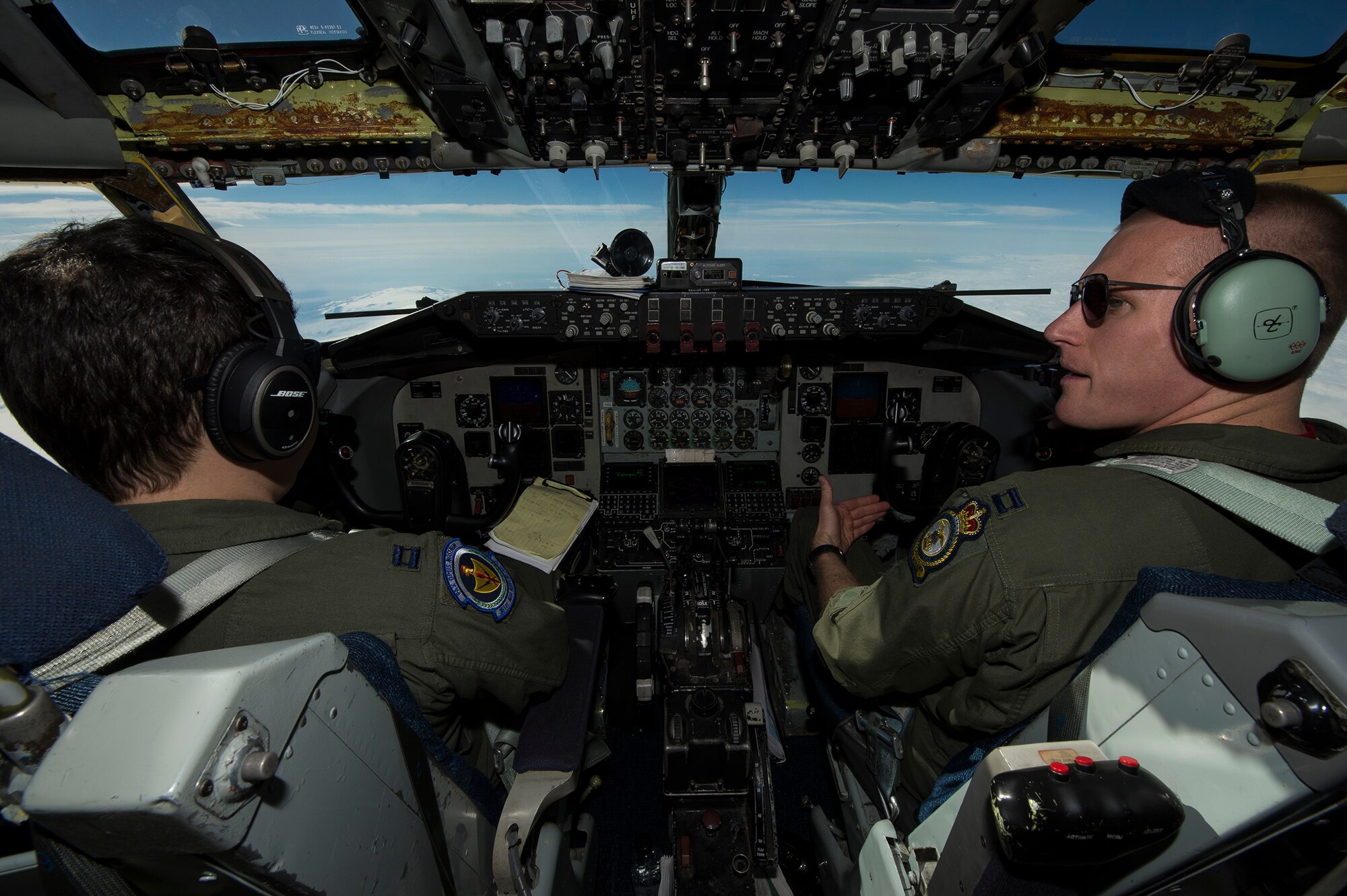 U.S. Air Force Captains Brian Dunn, left, and Justin Hauffe, 871st Air Expeditionary Squadron KC-135 Stratotanker pilots, fly over Iceland while refueling an F-15C Eagle fighter aircraft during the Icelandic Air Surveillance and Policing mission April 22, 2015. The KC-135 is a force multiplier, increasing the range and mission effectiveness of the fighter assets in the air. The IAS mission is a recurring NATO commitment designed to maintain the security of Icelandic airspace by providing a fighter aircraft presence in the region. (U.S. Air Force photo by Staff Sgt. Chad Warren/Released)