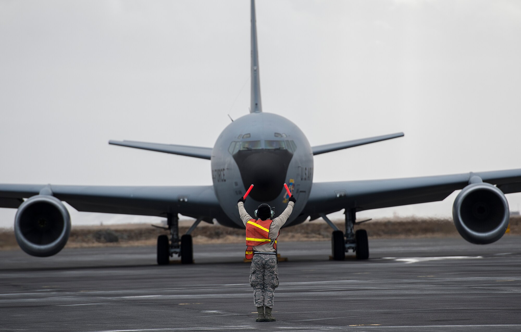 U.S. Air Force Senior Airman Tyler Miller, an 871st Air Expeditionary Squadron aero repair technician, taxis a KC-135 Stratotanker aircraft before takeoff during the Icelandic Air Surveillance and Policing mission at the Keflavik International Airport April 21, 2015. The IAS mission is a recurring NATO commitment designed to maintain the security of Icelandic airspace by providing a fighter aircraft presence in the region. (U.S. Air Force photo by Staff Sgt. Chad Warren/Released)