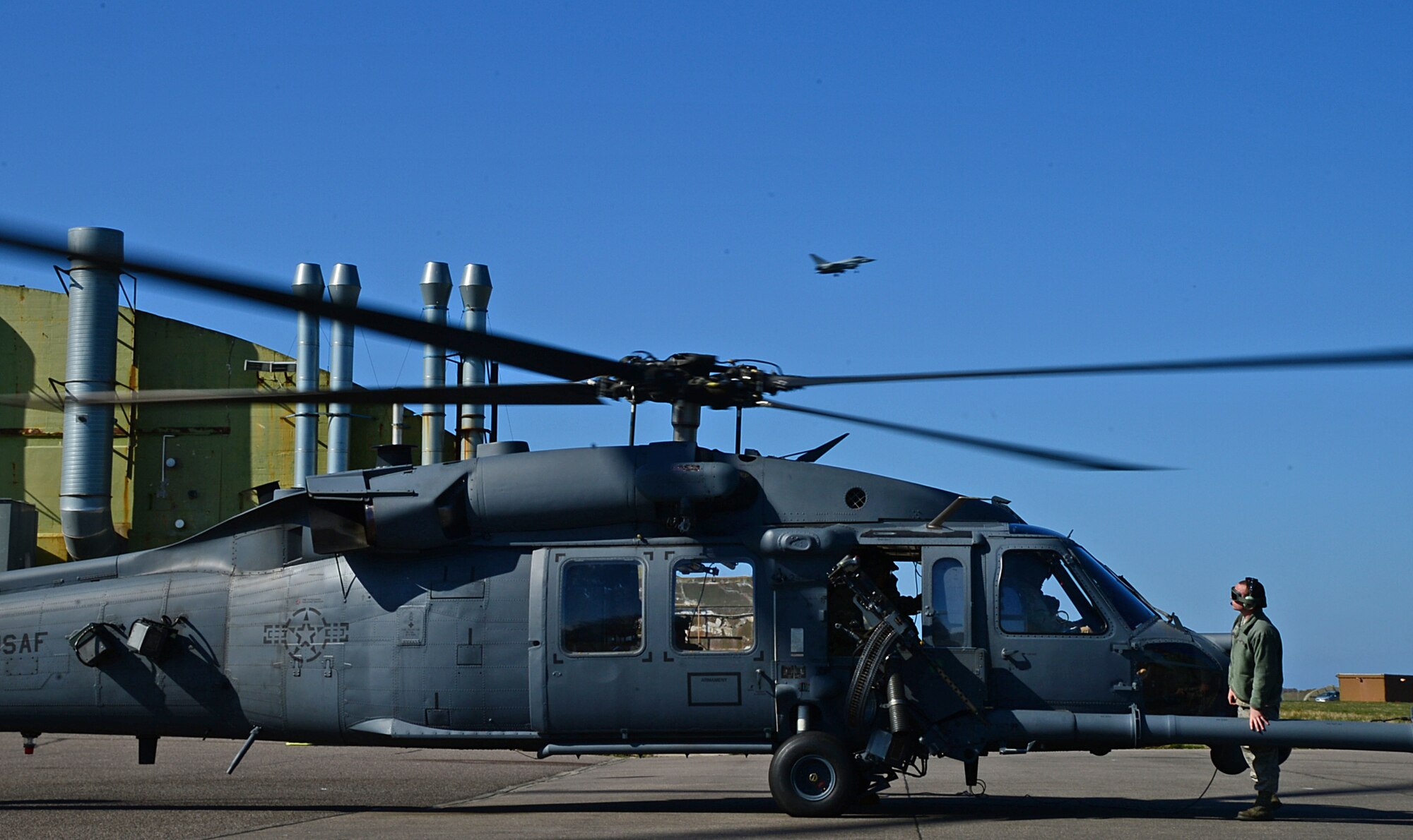 A maintainer from Royal Air Force Lakenheath's 56th Helicopter Maintenance Unit inspects a U.S. Air Force HH-60G Pave Hawk helicopter assigned to 56th Rescue Squadron during exercise Joint Warrior 15-1 in Scotland, April 20, 2015. Maintainers work day and night shifts to ensure the helicopters are in pristine condition for flight operations during training operations. (U.S. Air Force photo by Senior Airman Erin O'Shea/Released)