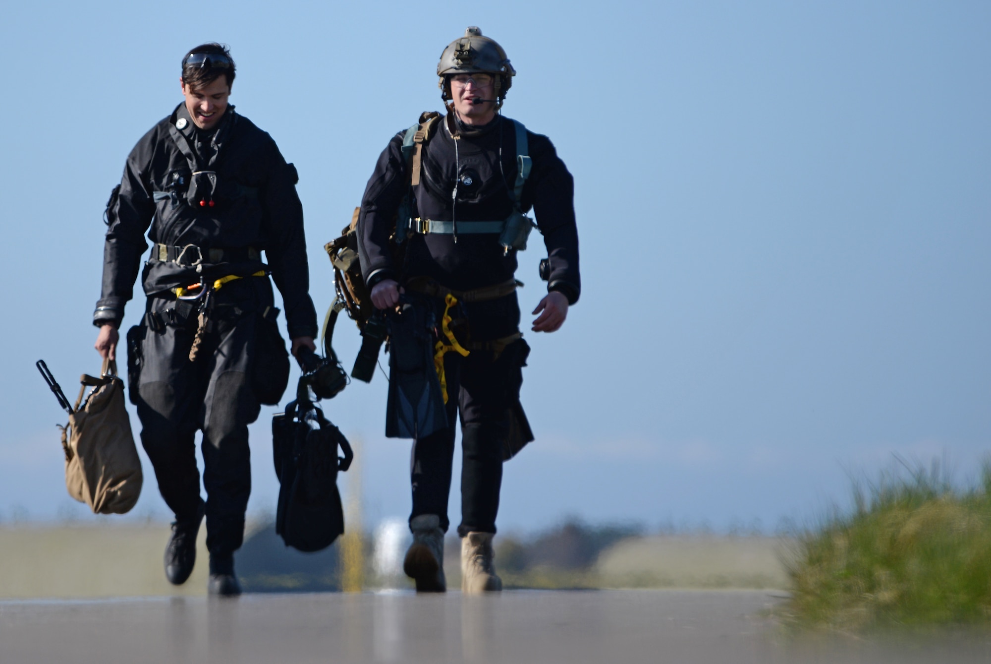 Pararescuemen assigned to Royal Air Force Lakenheath’s 57th Rescue Squadron walk toward their training area after a flight operation during exercise Joint Warrior 15-1 in Scotland, April 20, 2015. U.S. Air Force personnel from the 56th and 57th RQSs participated in the exercise to enhance their ability to operate with NATO allies. (U.S. Air Force photo by Senior Airman Erin O'Shea/Released)