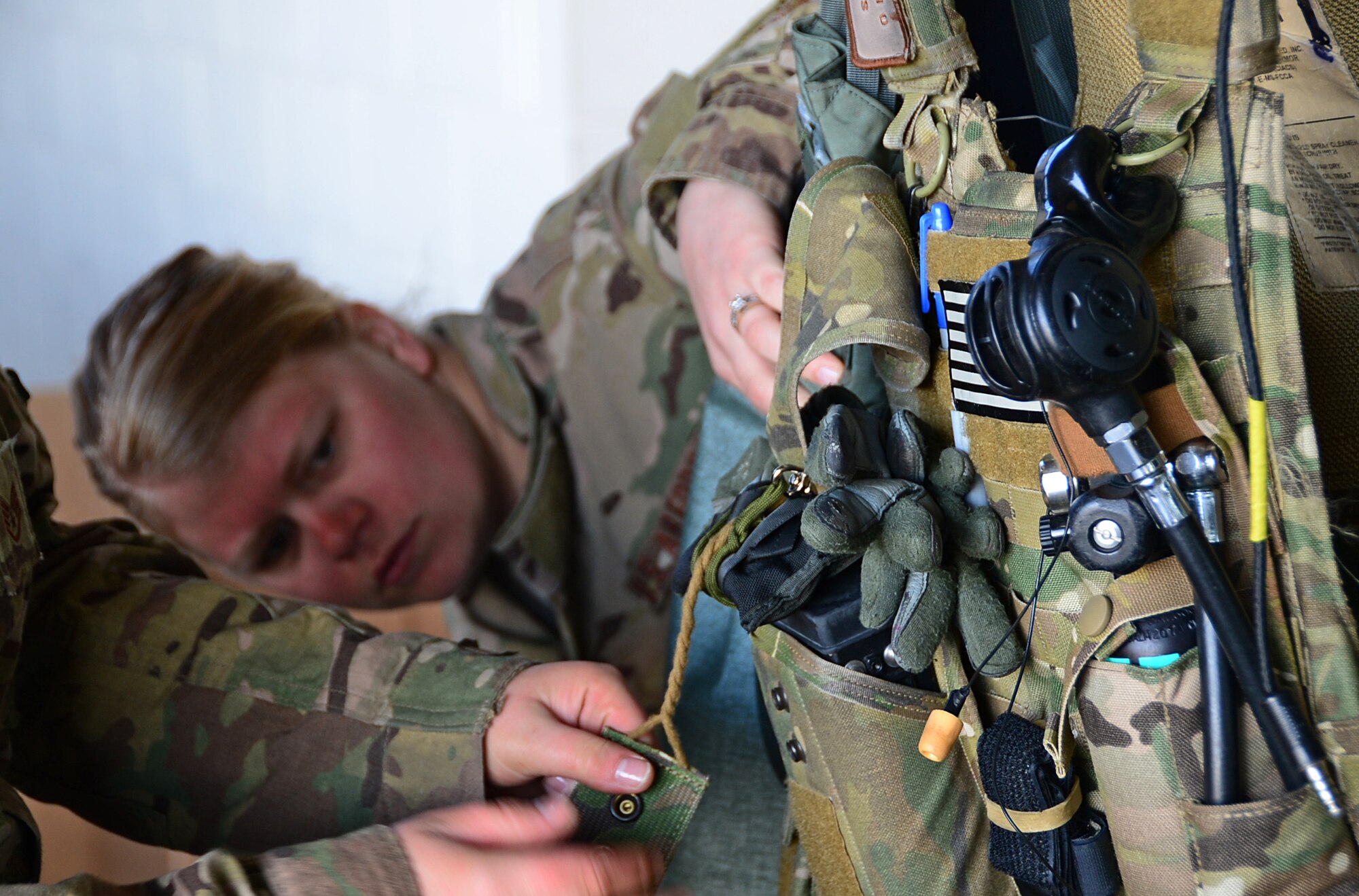 Senior Airman Kayla Lee, 56th Rescue Squadron aviation resource management, inspects aircrew flight equipment during exercise Joint Warrior 15-1 in Scotland, April 20, 2015. AFE ensures aircrew gear is maintained and serviceable at a moment's notice. (U.S. Air Force photo by Senior Airman Erin O'Shea/Released)