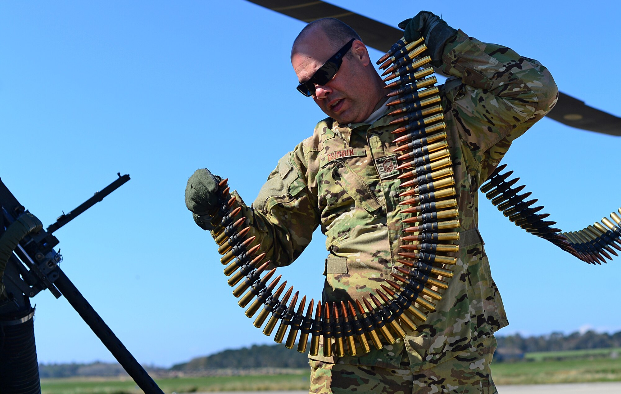 Master Sgt. John Durbin, U.S. Air Forces in Europe HH-60 command staff evaluator, loads ammunition onto an HH-60G Pave-Hawk during a training exercise in Scotland, April 2015. About 13,000 military members from 14 countries took part in exercise Joint Warrior 15-1. (U.S. Air Force photo by Senior Airman Erin O'Shea/Released)
