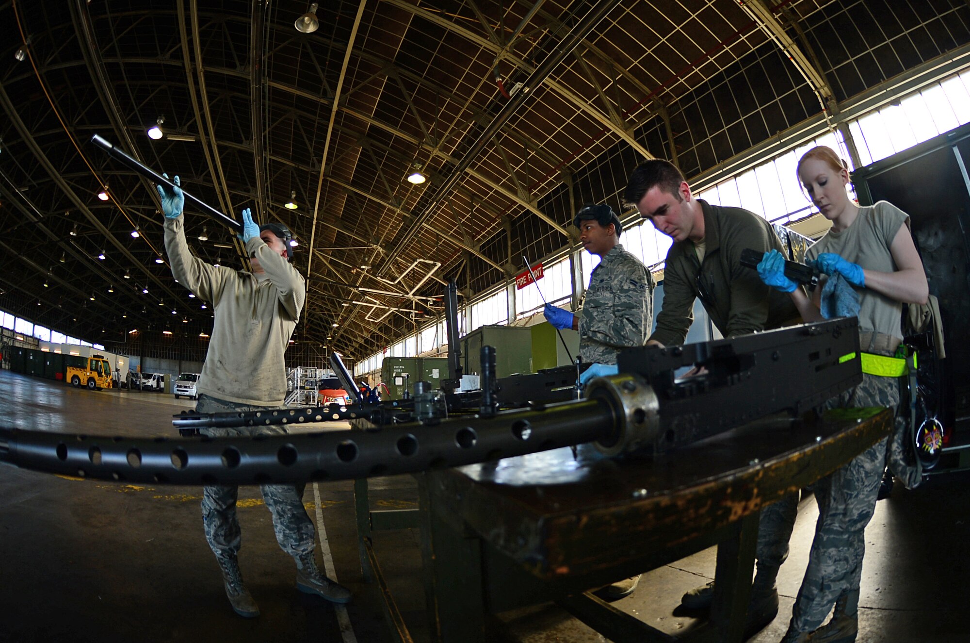 U.S. Air Force personnel assigned to the 56th Helicopter Maintenance Unit, clean and inspect .50-caliber machine guns before loading them onto HH-60G Pave Hawk helicopters during exercise Joint Warrior 15-1 in Scotland, April 20, 2015. These maintainers are responsible for ensuring the accuracy of the unit's  weapons. (U.S. Air Force photo by Senior Airman Erin O'Shea/Released) 