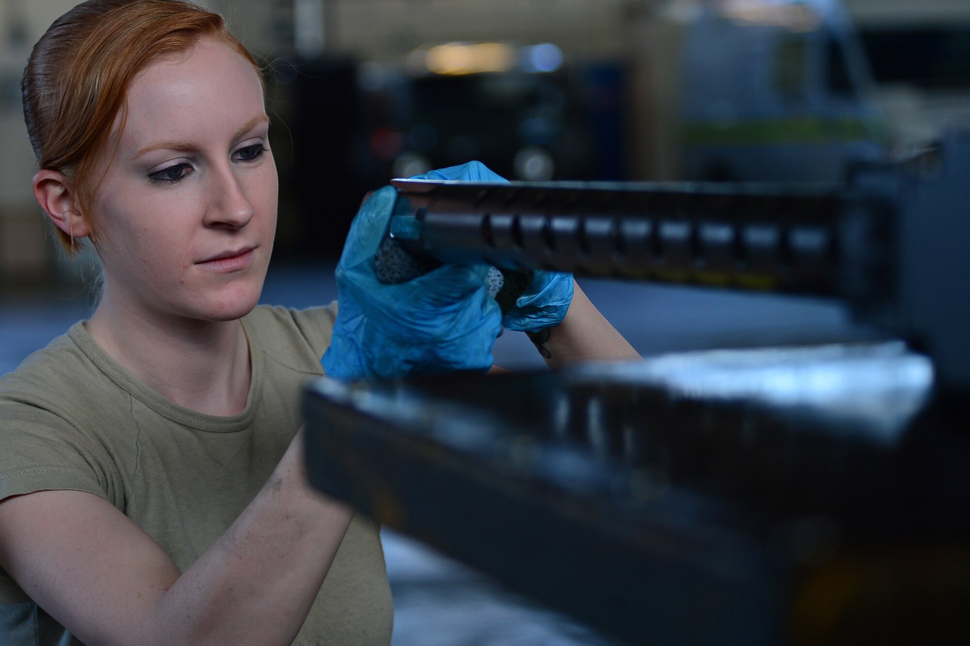 Airman 1st Class Abygail Reynolds, 56th Helicopter Maintenance Unit weapons team member, cleans and inspects a .50-caliber machine gun during exercise Joint Warrior 15-1 in Scotland, April 22, 2015. Reynolds is responsible for maintaining the unit's weapons and ensuring they work properly when the aircrew fire them. (U.S. Air Force photo by Senior Airman Erin O'Shea/Released) 
