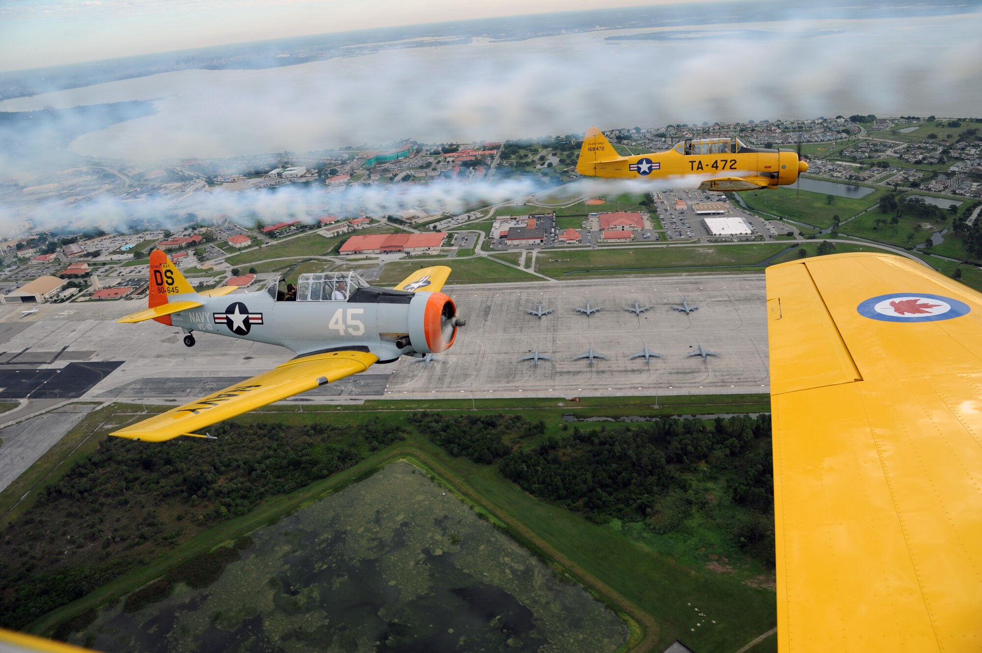 Reservists from the 927th Air Refueling Wing, MacDill Air Force Base, Fla., who looked to the sky, April 23, witnessed a formation of World War II era aircraft performing a military salute flyover. The dual-purpose mission included, nine aircraft, a B-25, four T-6s and four Yaks that were in town to perform at the Sun N’ Fun International Air show, Lakeland, Fla. In addition to the military salute, the intent of the formation flight was to bring community awareness to the My MacDill Campaign. An educational campaign designed to highlight the strategic and economic importance of MacDill AFB. (U.S. Air Force Photo/ Tech. Sgt. Peter Dean)  