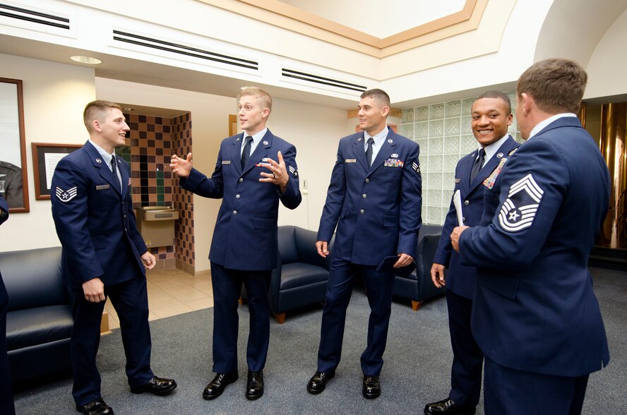 U.S. Air Force Senior Airman John C. Brantley, second from left, assigned to the 165th Air Support Operations Squadron, Georgia Air National Guard, relives memories from the past few months of training with fellow Tactical Air Control Party graduates before their official ceremony at Hurlburt Field, Fla., April 17, 2015. With the intense training being more than three months and often taking longer for some of the cadets, the sense of brotherhood is the main thing that helped them overcome the challenges they faced. (U.S. Air Force photo by Staff Sgt. Brigitte N. Brantley/Released)