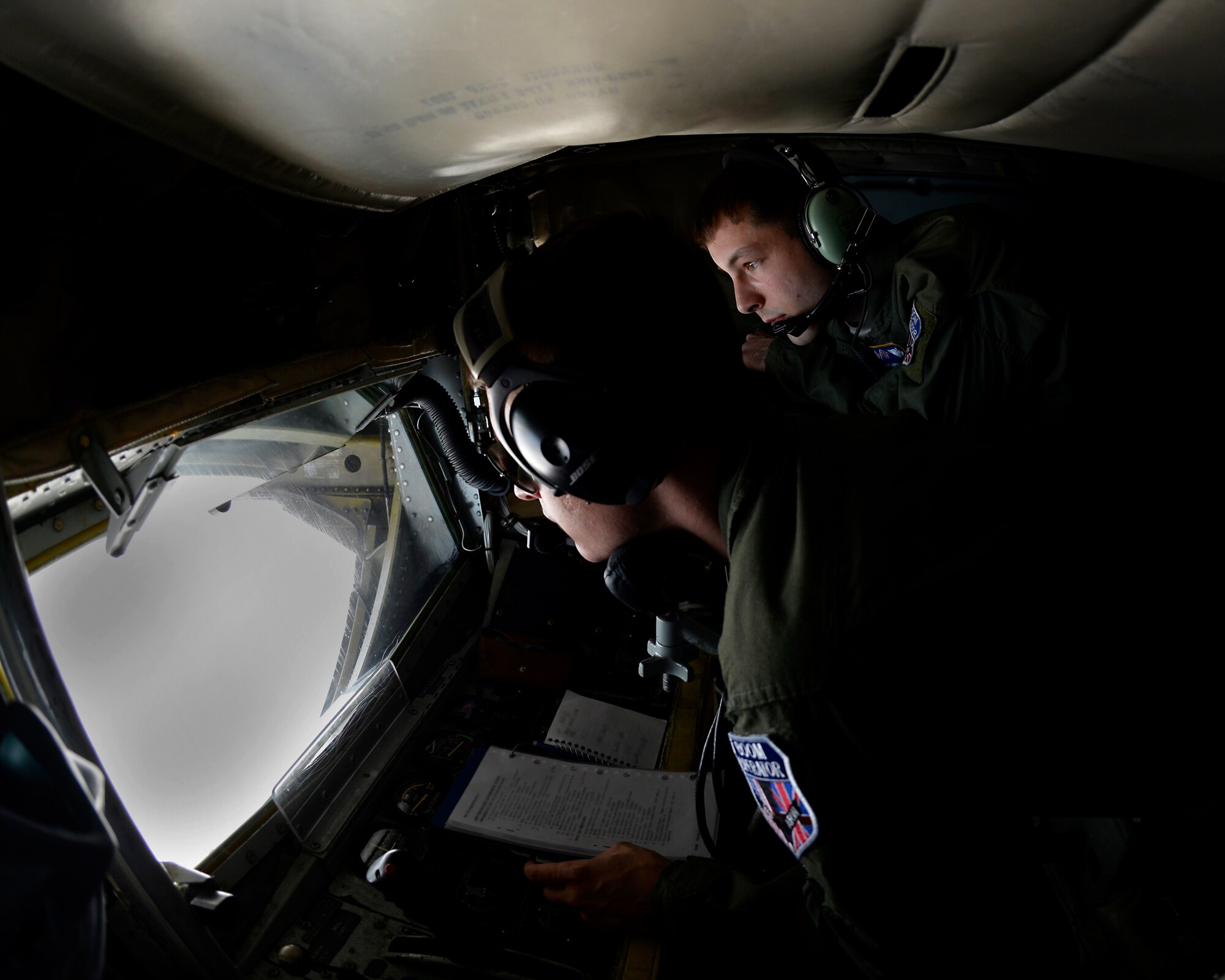 U.S. Air Force Staff Sgt. Andrew Valence, 100th Operations Support Squadron in-flight refueling instructor from Anderson, S.C., shadows Airman Nicholas Sowder, 351st Air Refueling Squadron boom operator from Madrid, Iowa, while participating in the Baltic Region Training Event April 22, 2015, over the Baltic region. The training event was held to enhance relations between air forces in the region, support air-land-integration, and develop interoperability among allies and with local air traffic control agencies. (U.S. Air Force photo by Senior Airman Victoria H. Taylor/Released)