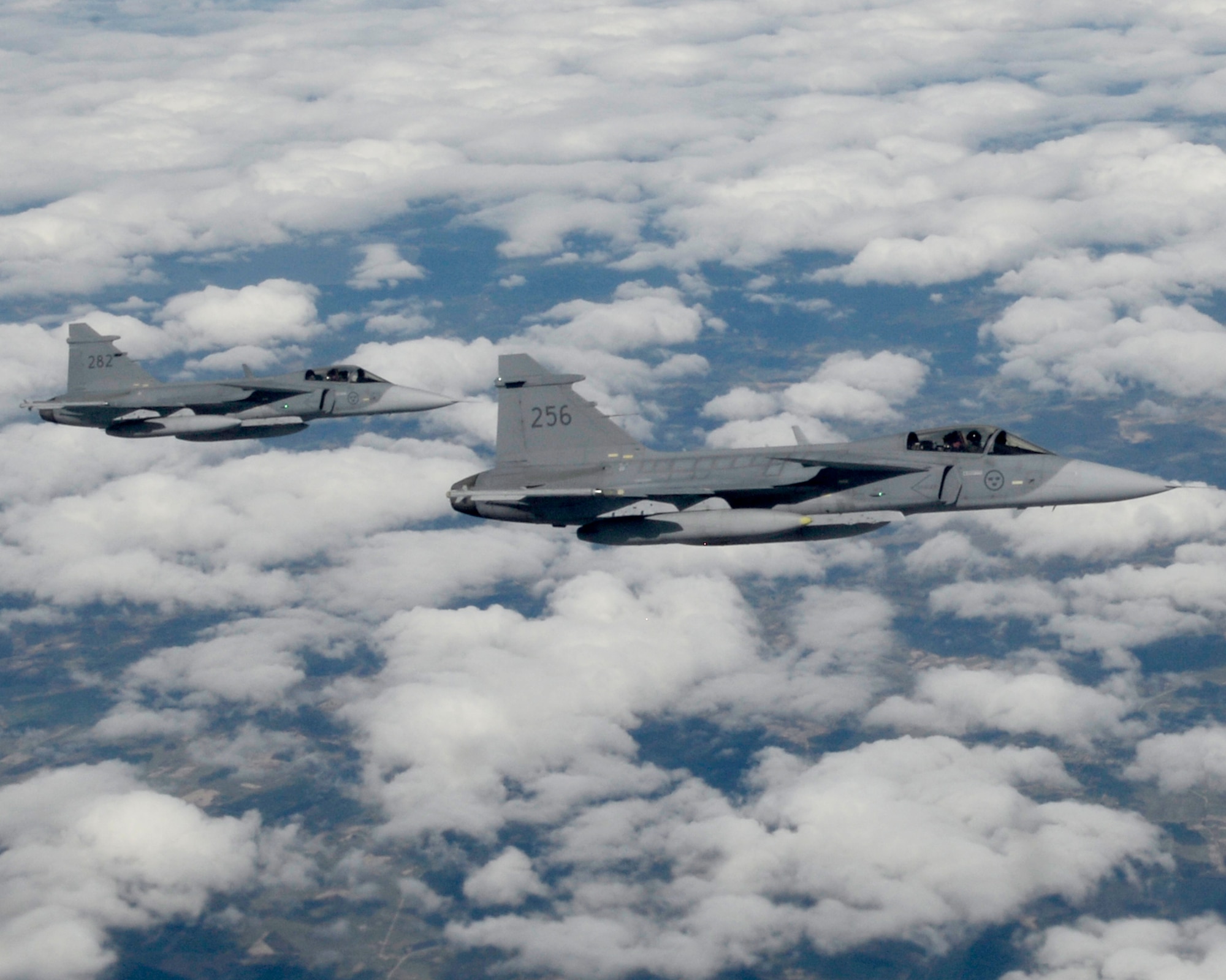 Two JAS-39 Gripens assigned to the Swedish Air Force participate in the Baltic Region Training Event April 22, 2015, over the Baltic region. The training event was held to enhance relations between air forces in the region, support air-land-integration, and develop interoperability among allies and with local air traffic control agencies. (U.S. Air Force photo by Senior Airman Victoria H. Taylor/Released)